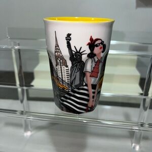 Nicole Lee White Ceramic Travel Mug with Yellow Interior and Black/Red Artwork